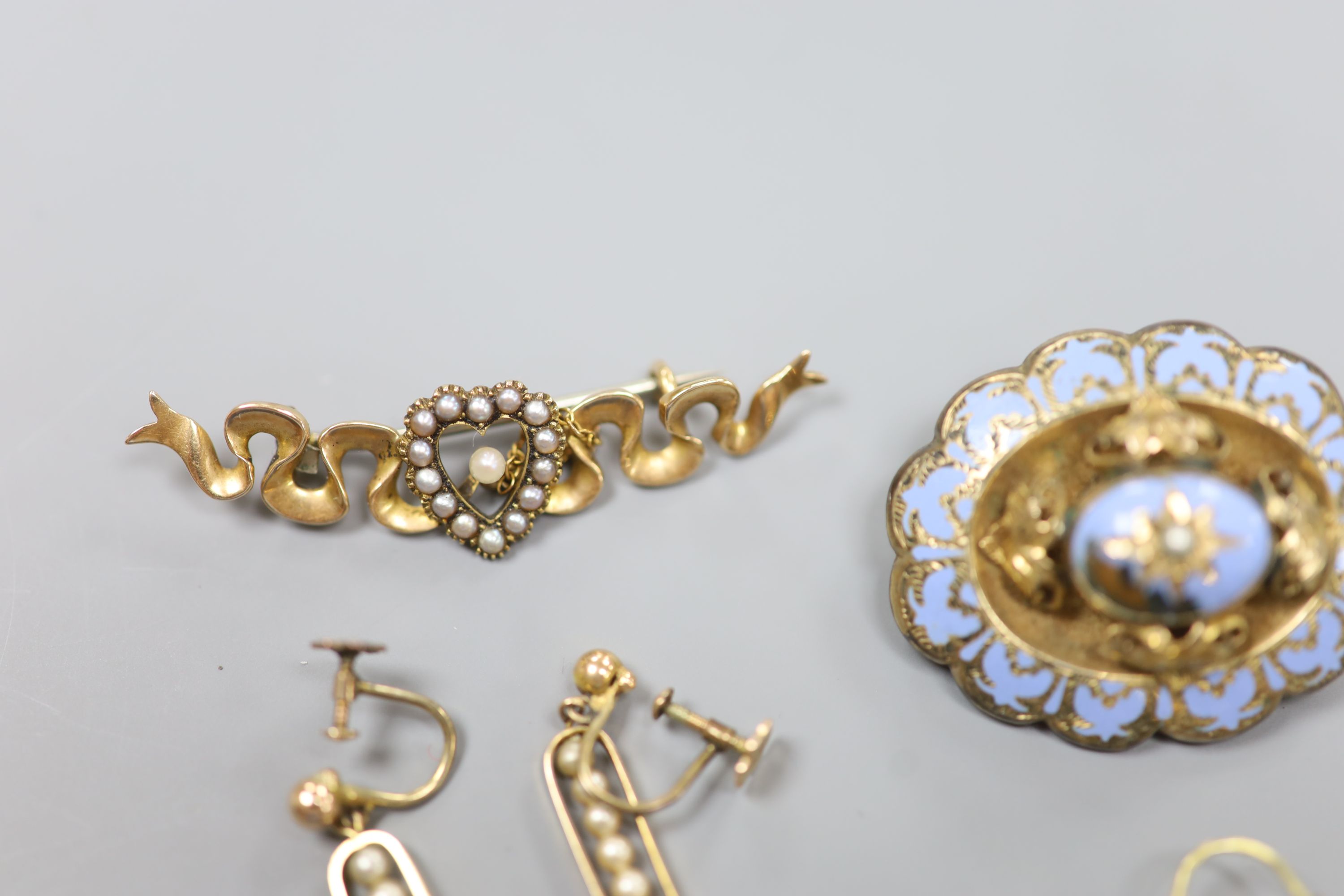 An Edwardian 15ct and seed pearl set bar brooch, 47mm, gross 4 grams, two pairs of 9ct earrings, gross 5,2 grams and a Victorian yellow metal and enamel (a.f.) mourning brooch.